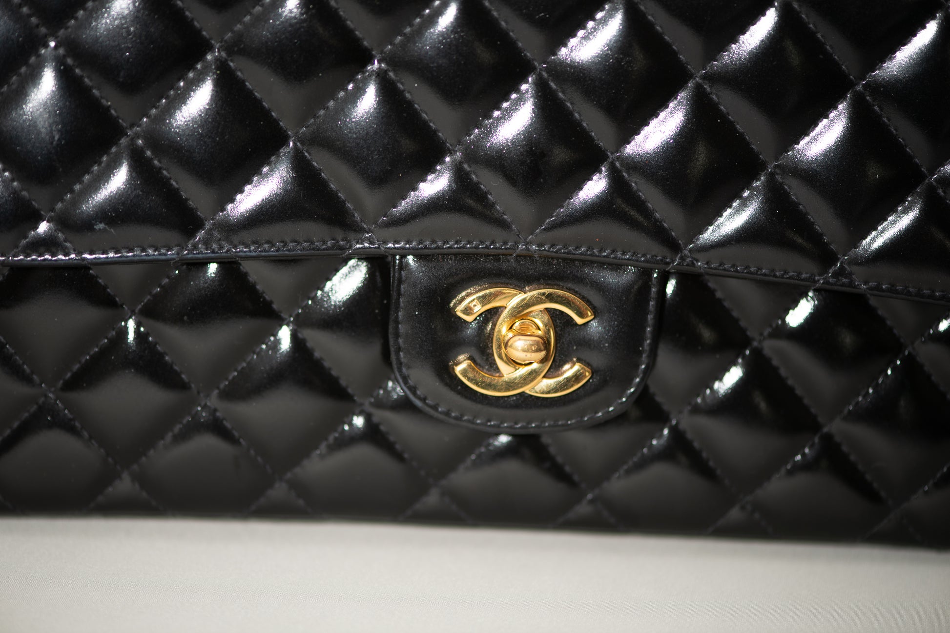 Authentic vintage Chanel Kelly Top Handle handbag in black quilted leather with 24K gold hardware