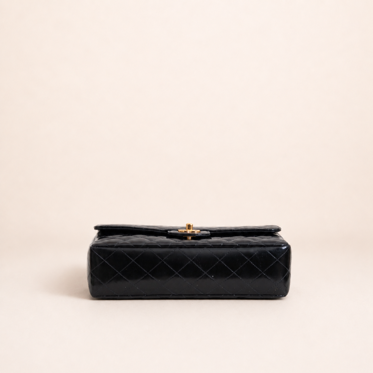 Authentic vintage Chanel Kelly Top Handle handbag in black quilted leather with 24K gold hardware