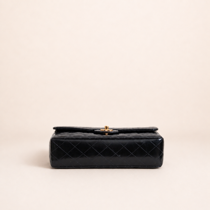 Authentic vintage Chanel Kelly Top Handle handbag in black quilted leather with 24K gold hardware