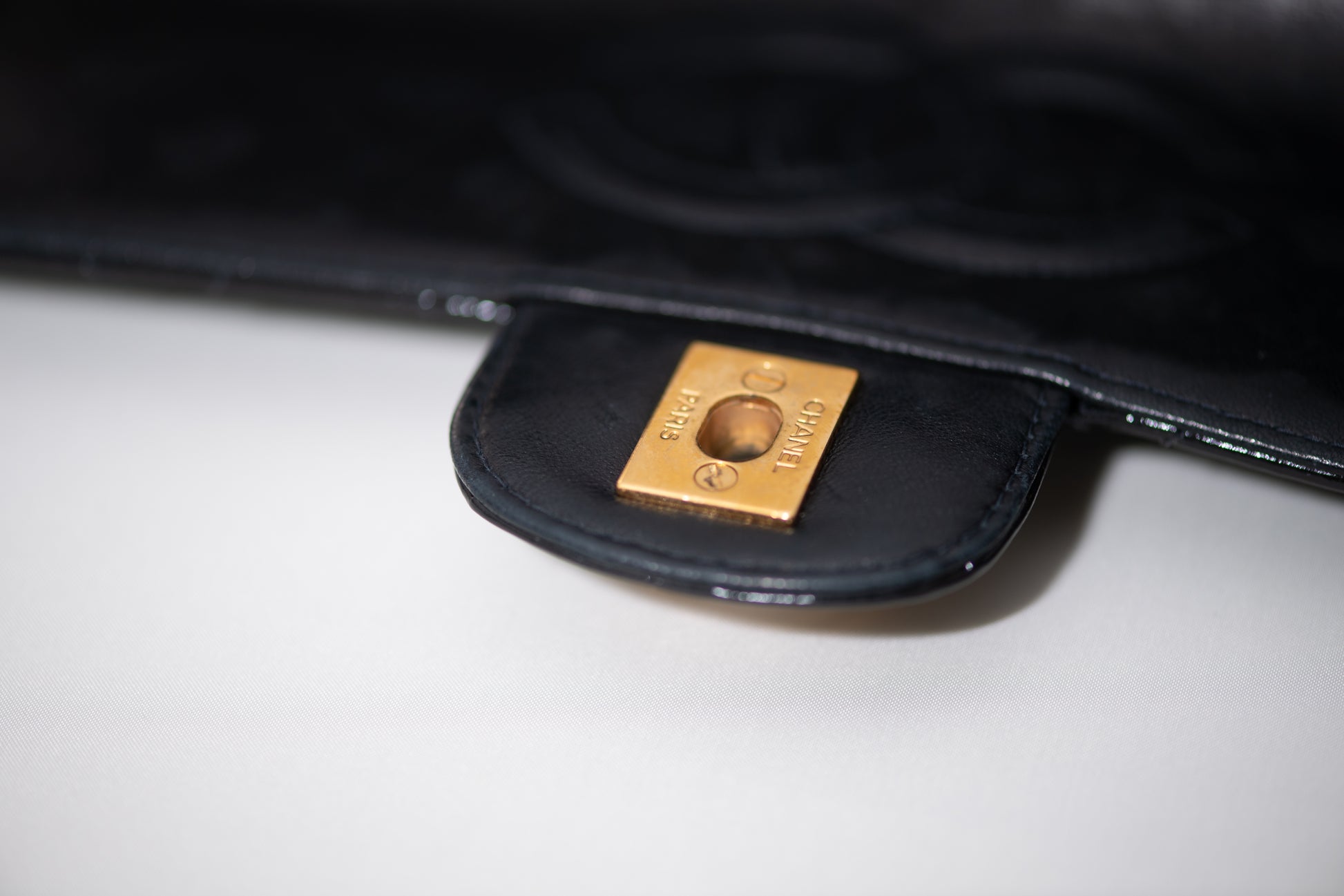 Authentic vintage Chanel Kelly Top Handle handbag in black quilted leather with 24K gold hardware