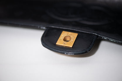 Authentic vintage Chanel Kelly Top Handle handbag in black quilted leather with 24K gold hardware