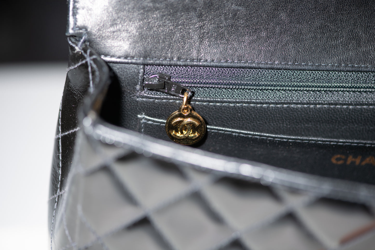 Authentic vintage Chanel Kelly Top Handle handbag in black quilted leather with 24K gold hardware