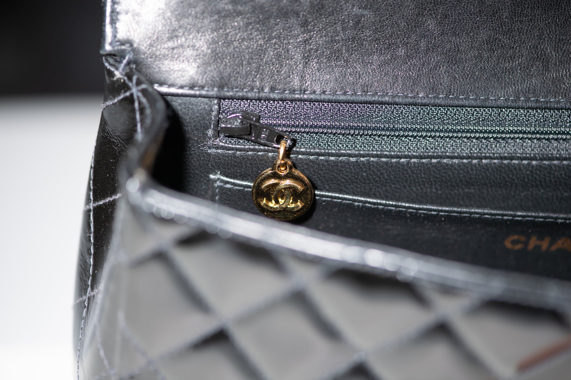 Authentic vintage Chanel Kelly Top Handle handbag in black quilted leather with 24K gold hardware