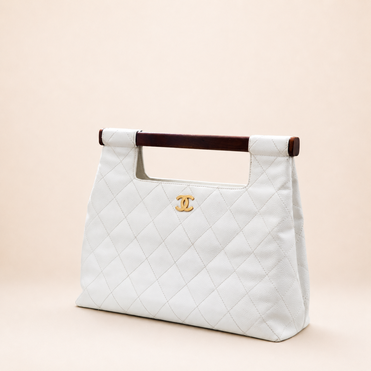 Rare authentic Chanel White Caviar Leather Wood Handle Bag with Matelassé quilting and gold-tone CC logo.