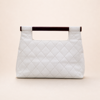 Rare authentic Chanel White Caviar Leather Wood Handle Bag with Matelassé quilting and gold-tone CC logo.