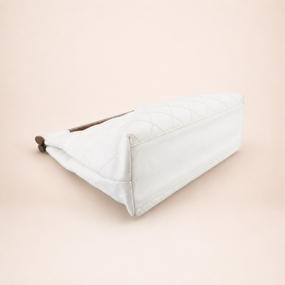 Rare authentic Chanel White Caviar Leather Wood Handle Bag with Matelassé quilting and gold-tone CC logo.