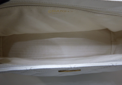 Rare authentic Chanel White Caviar Leather Wood Handle Bag with Matelassé quilting and gold-tone CC logo.