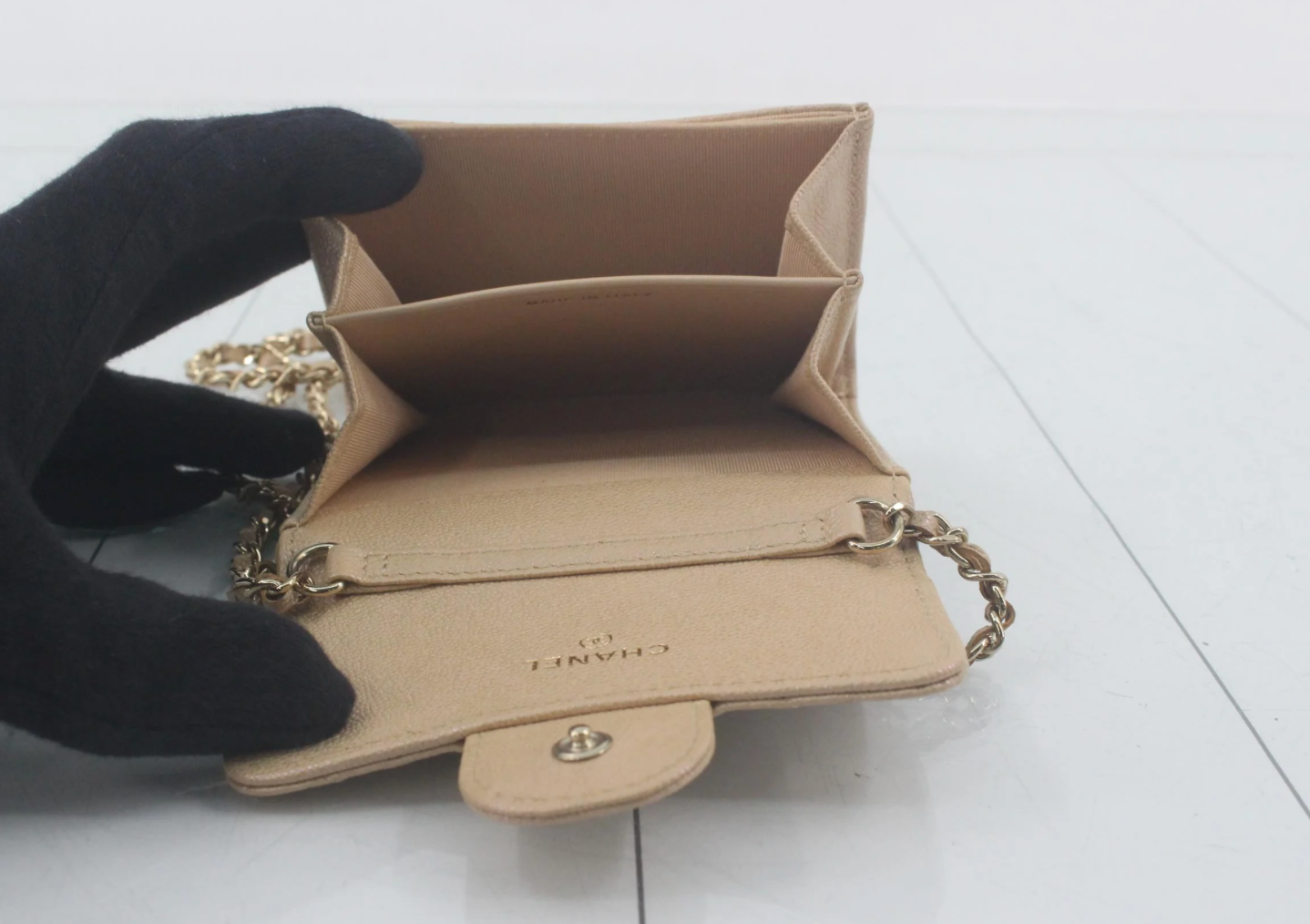 Authentic Chanel Wallet On Chain in beige caviar leather with Matelassé quilting and gold-tone hardware.