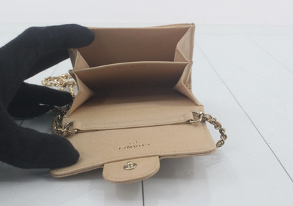 Authentic Chanel Wallet On Chain in beige caviar leather with Matelassé quilting and gold-tone hardware.