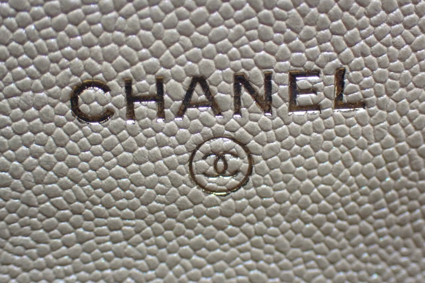 Authentic Chanel Wallet On Chain in beige caviar leather with Matelassé quilting and gold-tone hardware.