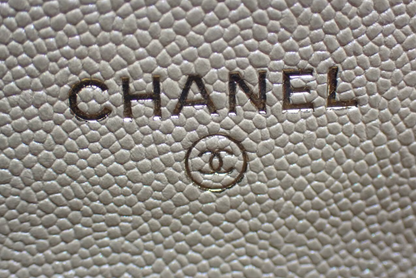 Authentic Chanel Wallet On Chain in beige caviar leather with Matelassé quilting and gold-tone hardware.