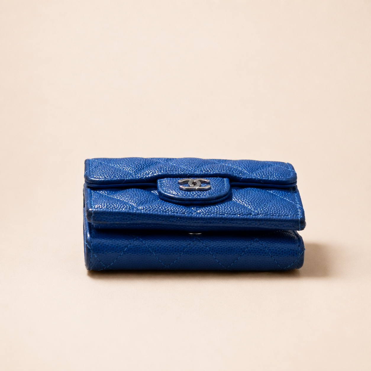 Authentic Vintage Chanel Compact Wallet in blue caviar leather with Matelassé quilting and silver CC logo.