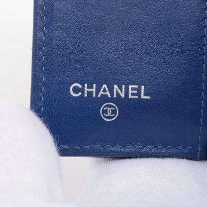 Authentic Vintage Chanel Compact Wallet in blue caviar leather with Matelassé quilting and silver CC logo.