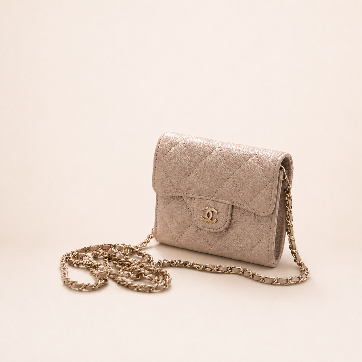 Authentic Chanel Wallet On Chain in beige caviar leather with Matelassé quilting and gold-tone hardware.