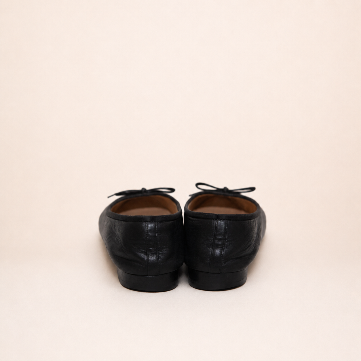 Authentic vintage Chanel Classic Ballerina flats in black leather with patent leather toe caps and CC logo