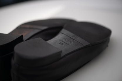 Authentic vintage Chanel Classic Ballerina flats in black leather with patent leather toe caps and CC logo