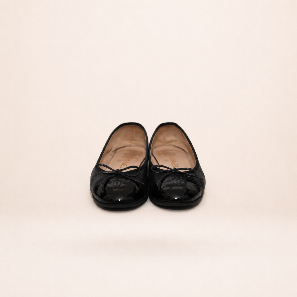 Authentic vintage Chanel Classic Ballerina flats in black leather with patent leather toe caps and CC logo