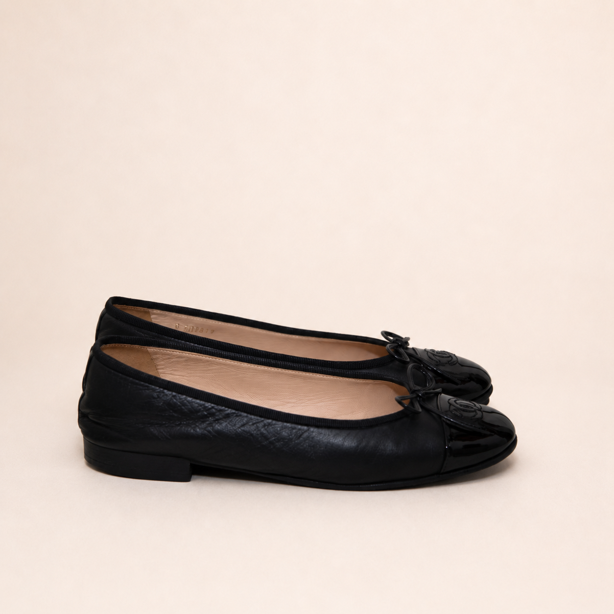 Authentic vintage Chanel Classic Ballerina flats in black leather with patent leather toe caps and CC logo